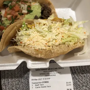 two tacos in a styrofoam container