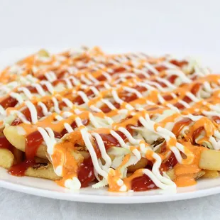 a plate of fries covered in ketchup and cheese