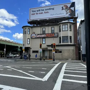 a billboard on the corner of a street