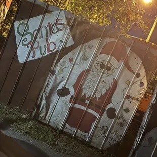 a santa clause painted on a fence