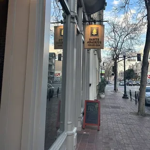 a view of a sidewalk in front of a building
