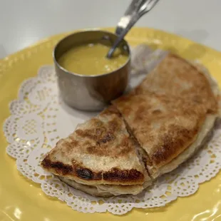 two quesadillas on a yellow plate