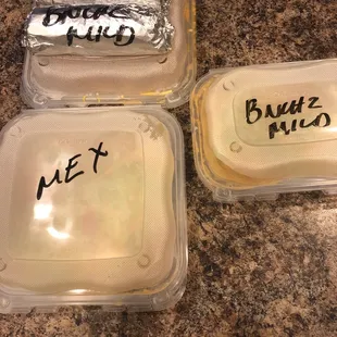 Clearly labeled food in plastic containers.