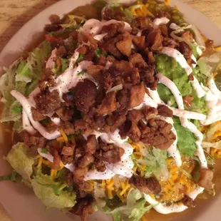 Indian Taco, bean and carnitas , extra hot green chili, chicharrones, guacamole and sour cream. A mountain of food but I ate all!