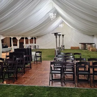 Tent 30x60 with ivory draping chandeliers,mahogany chairs , dance floor , patio heaters etc