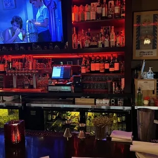 a bar with a large screen tv