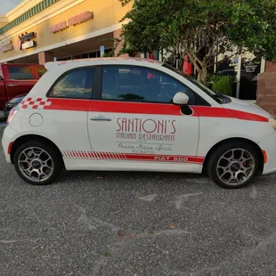 a small car parked in a parking lot