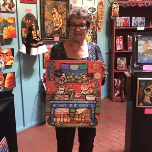 This is the owners mom Angie. A very nice genuine lady.  She posed with one of the pieces of art.