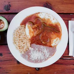 Huevos Rancheros: 3 fried eggs w/special savory sauce, rice, beans.