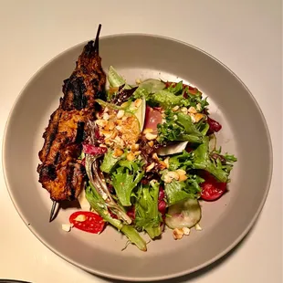 a plate of food with meat and vegetables