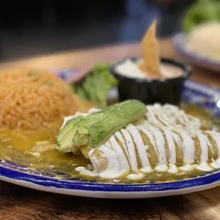 a plate of enchilada and rice
