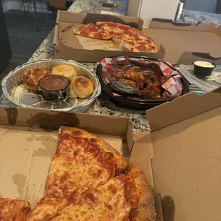 Cheese pizza , pepperoni and pineapple pizza , spicy Asian wings and garlic rolls !