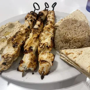 a plate of grilled meat and rice