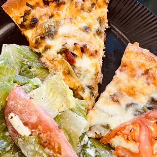 Dinner time from Santorini&apos;s. Pesto pizza top, Veggie on right, Greek Salad on left.