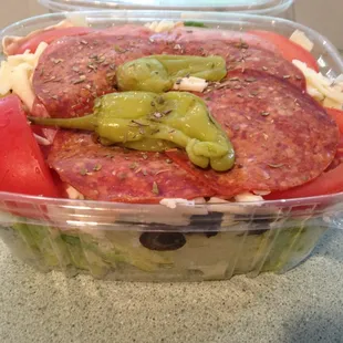 Antipasto salad packed in the to go container.