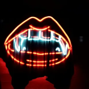 a neon mouth with glowing teeth