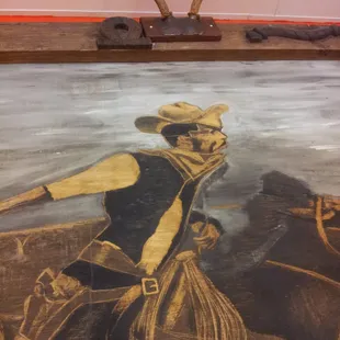 a cowboy riding a horse with antlers