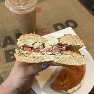 a person holding a half eaten sandwich