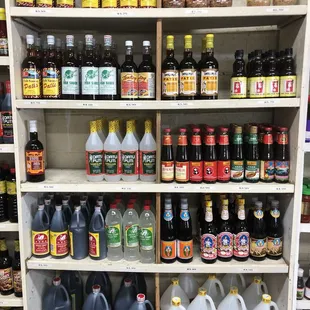 a shelf full of bottles of liquid