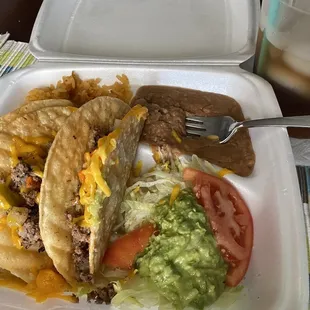 a plate of tacos and a drink
