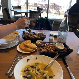 a bowl of soup and a plate of bread