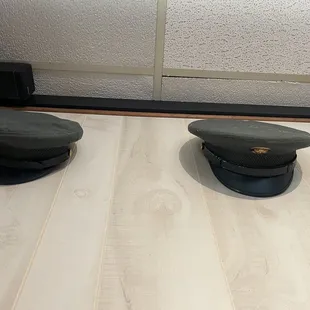 two hats on a wooden floor