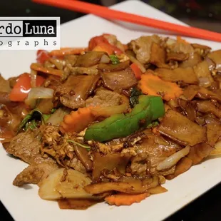 a plate of food with chopsticks