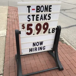 a sign on a sidewalk