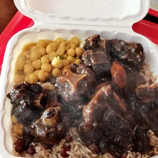 Oxtail stew with rice and beans and a side of chick peas.