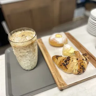 a glass of iced coffee and pastries