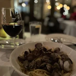 a bowl of pasta and a glass of wine