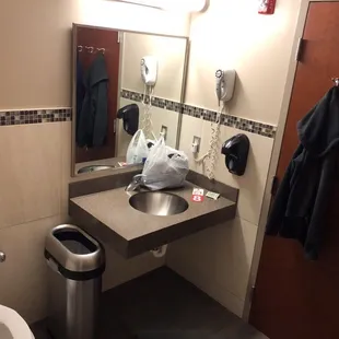 a bathroom with a trash can