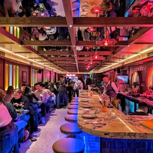 people sitting at the bar in a restaurant
