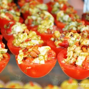 Stuffed Tomato Appetizer--with pesto, fresh mozzarella, and pine nuts