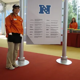 Owner Kim K at NFL Tailgate Party at Super Bowl XLIX, with sign of our custom salsas for each NFC team