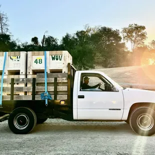 a white truck with crates in the back