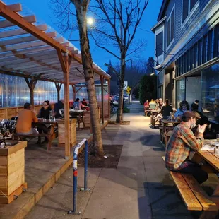 a group of people sitting at picnic tables