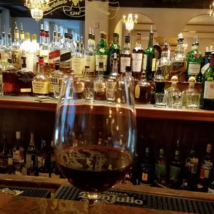 a glass of wine on the bar