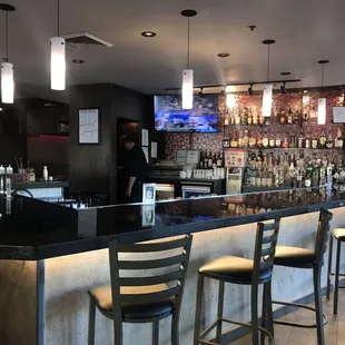 Alcohol bar and the bartender. Wonderful selection of liquor.