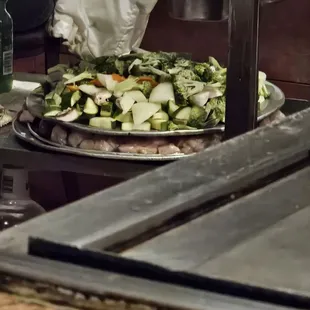 a pizza being prepared in a kitchen