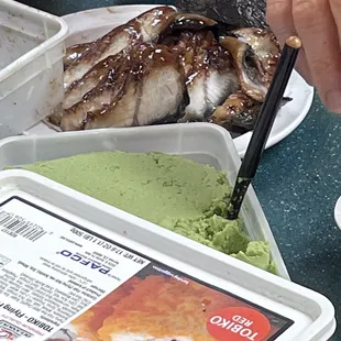 a person eating a sushi with chopsticks