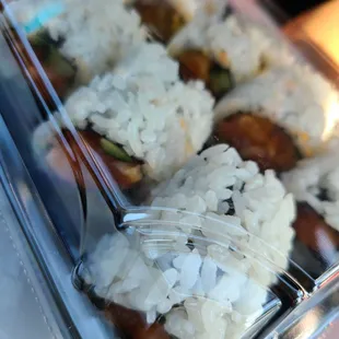 a plastic container with rice and vegetables