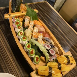 a wooden boat filled with sushi