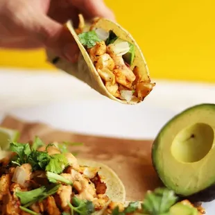 a hand holding a tortilla