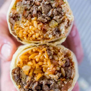 two burritos filled with meat and cheese