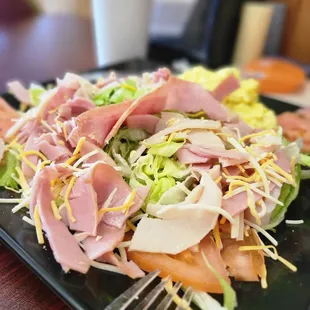 a salad with ham and lettuce