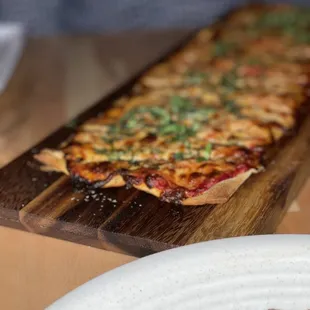a pizza on a cutting board