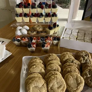 Snickerdoodle cookies in front, Tres Leches Trifle Cup on the bottom of the back stand, lemon curd and berry trifle cups on top