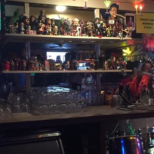 a bar with a lot of toys on the shelves
