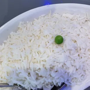 a plate of rice and a green pea
